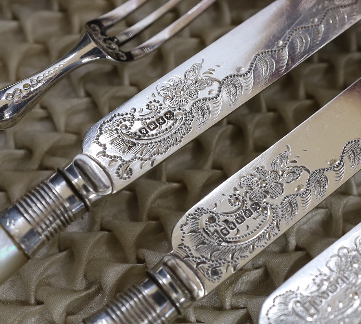An Edwardian cased set of mother of pearl handled plated dessert knives and forks with silver collars, Sheffield 1901